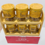 Glass pantry jars with bamboo lids and a wooden stand.