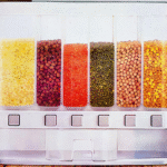 This is a wall-mounted dry food or cereal dispenser.