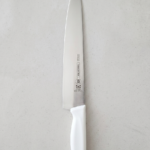 original Tramontina professional kitchen knife with a white handle.