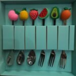 6-piece stainless steel dessert spoon and fork set featuring colorful, cartoon-style donut decorations on the handles.